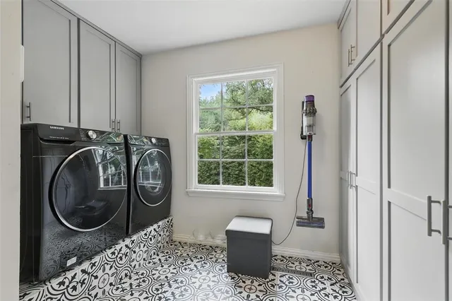 a bathroom with a toilet a sink a mirror and a window