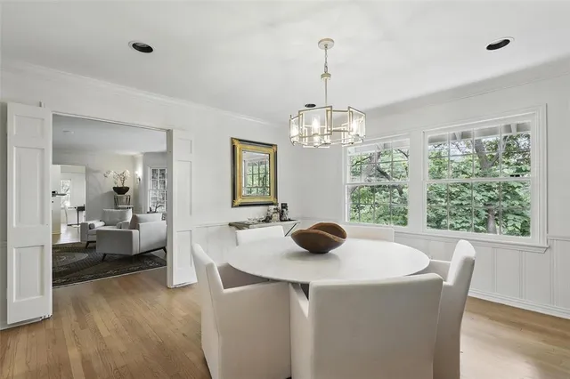 a dining room with furniture and a chandelier
