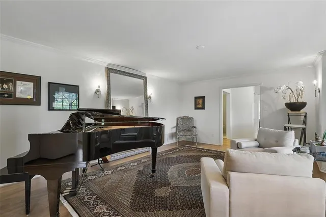 a living room with furniture and a piano