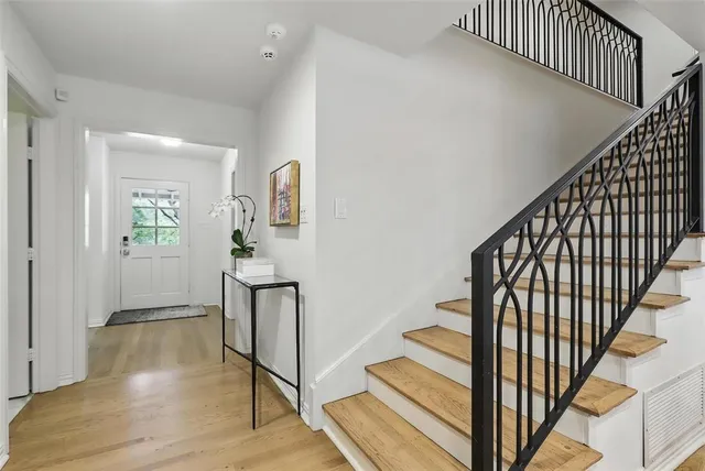 a view of staircase with wooden floor and a potted plant