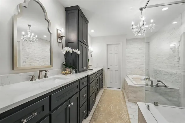 a spacious bathroom with a double vanity sink a large mirror and a shower