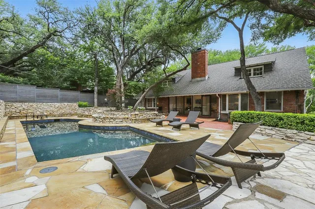 a view of a house with swimming pool and sitting area