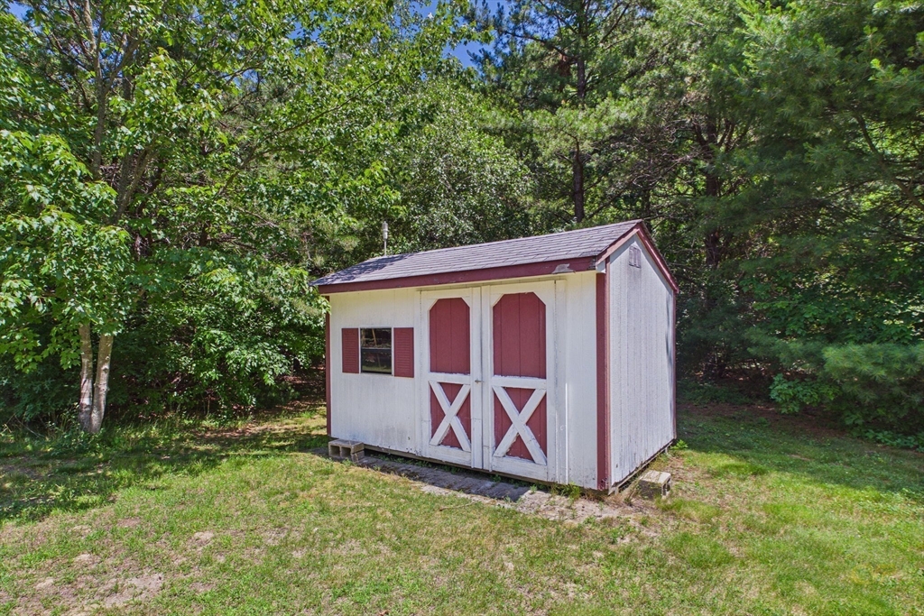 8 Cotuit Road Taunton, MA 02718 - Photo 22 of 24 a view of a backyard with a barn and large trees