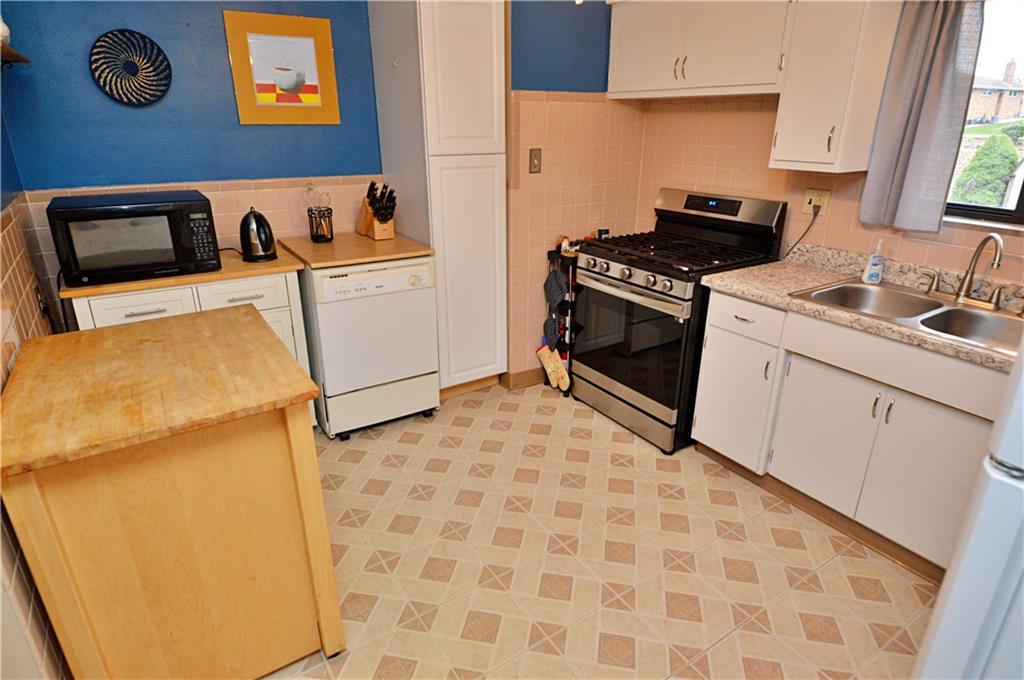 109 Thorncrest Drive McKees Rocks, PA 15136 - Photo 11 of 37 a kitchen with a stove a sink and a refrigerator