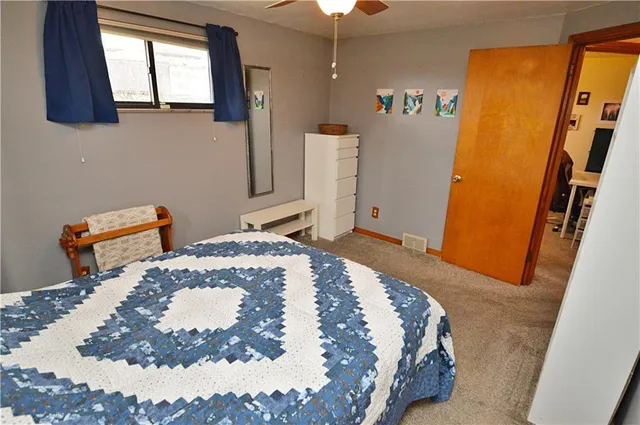 a bed sitting in a bedroom next to a window