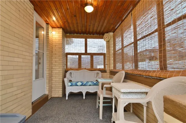 a dining room with furniture and a floor to ceiling window