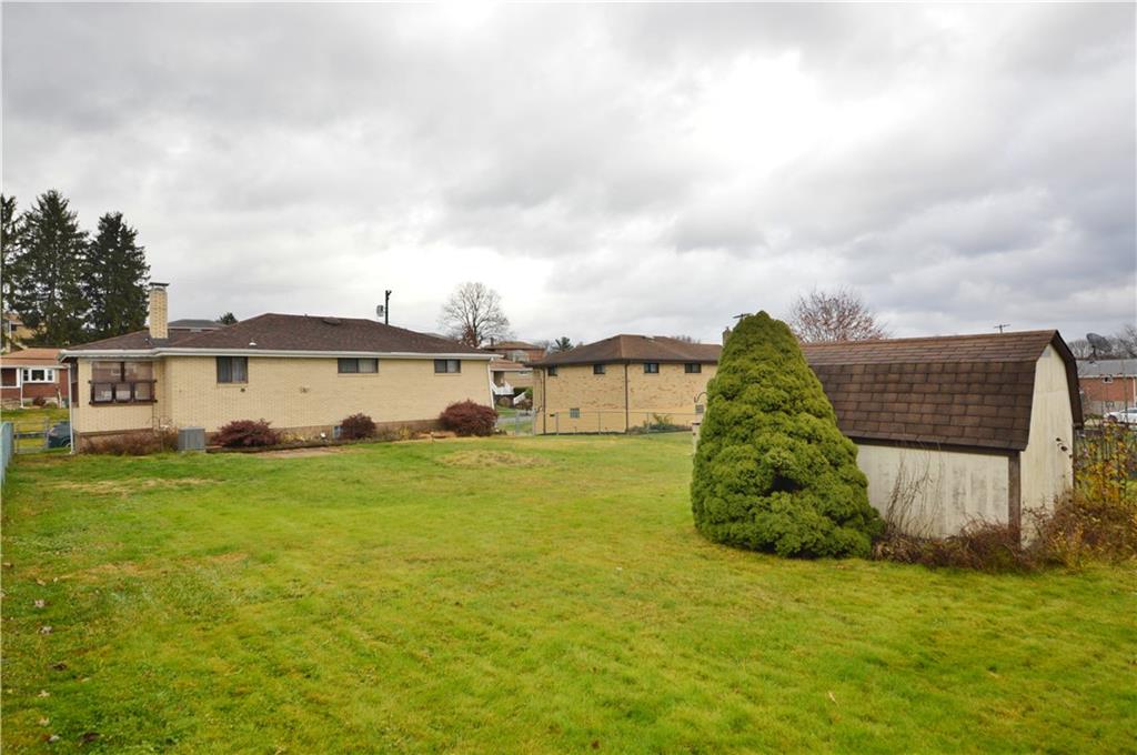 109 Thorncrest Drive McKees Rocks, PA 15136 - Photo 37 of 37 a view of a big house with a big yard and large tree
