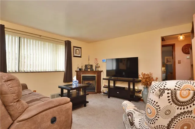 a bedroom with furniture and a flat screen tv