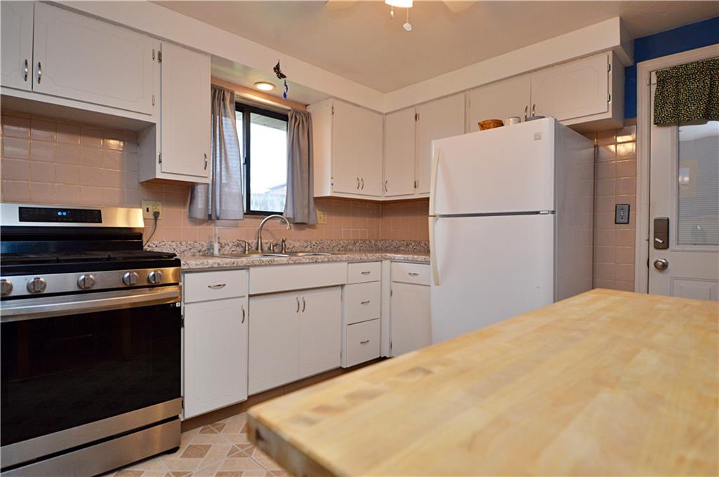 109 Thorncrest Drive McKees Rocks, PA 15136 - Photo 7 of 37 a kitchen with a stove a refrigerator and a sink