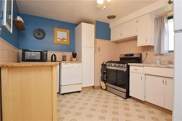 a kitchen with stainless steel appliances a refrigerator sink and cabinets