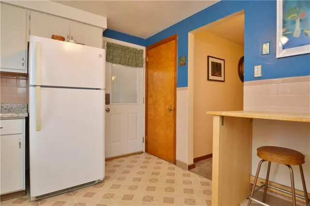 a view of kitchen with a refrigerator