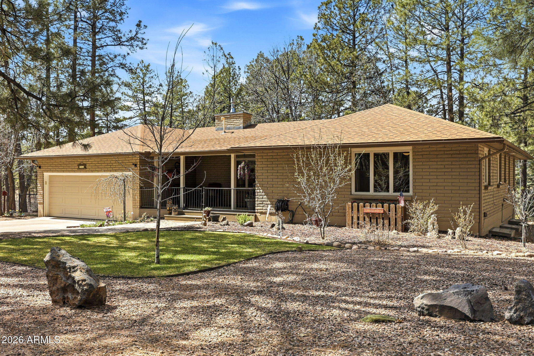 233 East Turkey Track Lane Pinetop, AZ 85935 - Photo 1 of 59 a front view of a house with garden and patio