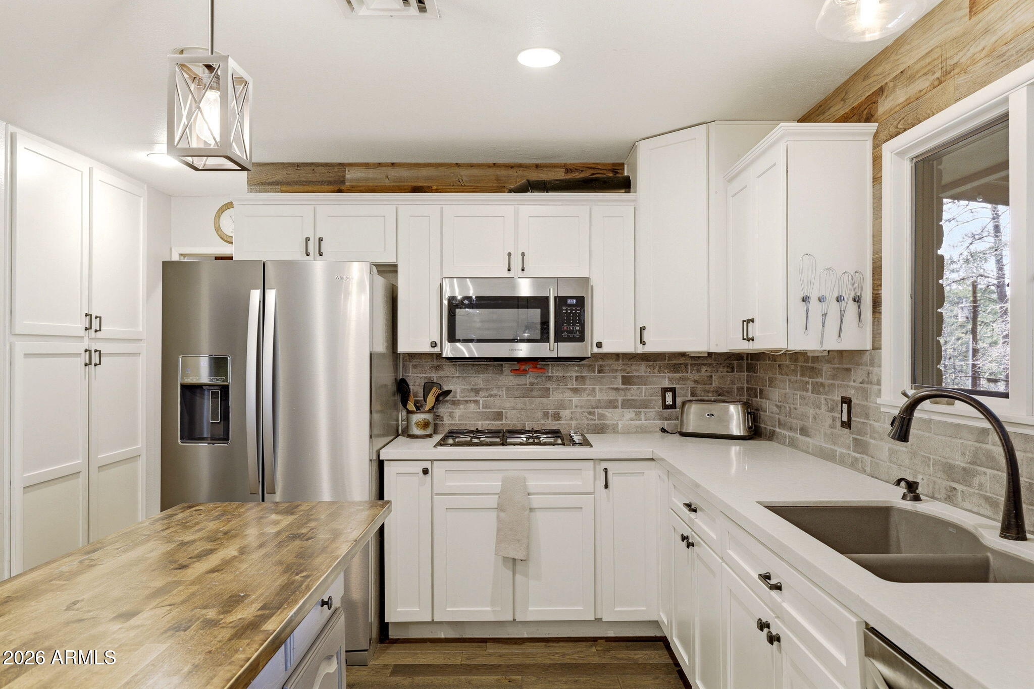 233 East Turkey Track Lane Pinetop, AZ 85935 - Photo 13 of 59 a kitchen with granite countertop a sink stainless steel appliances and white cabinets