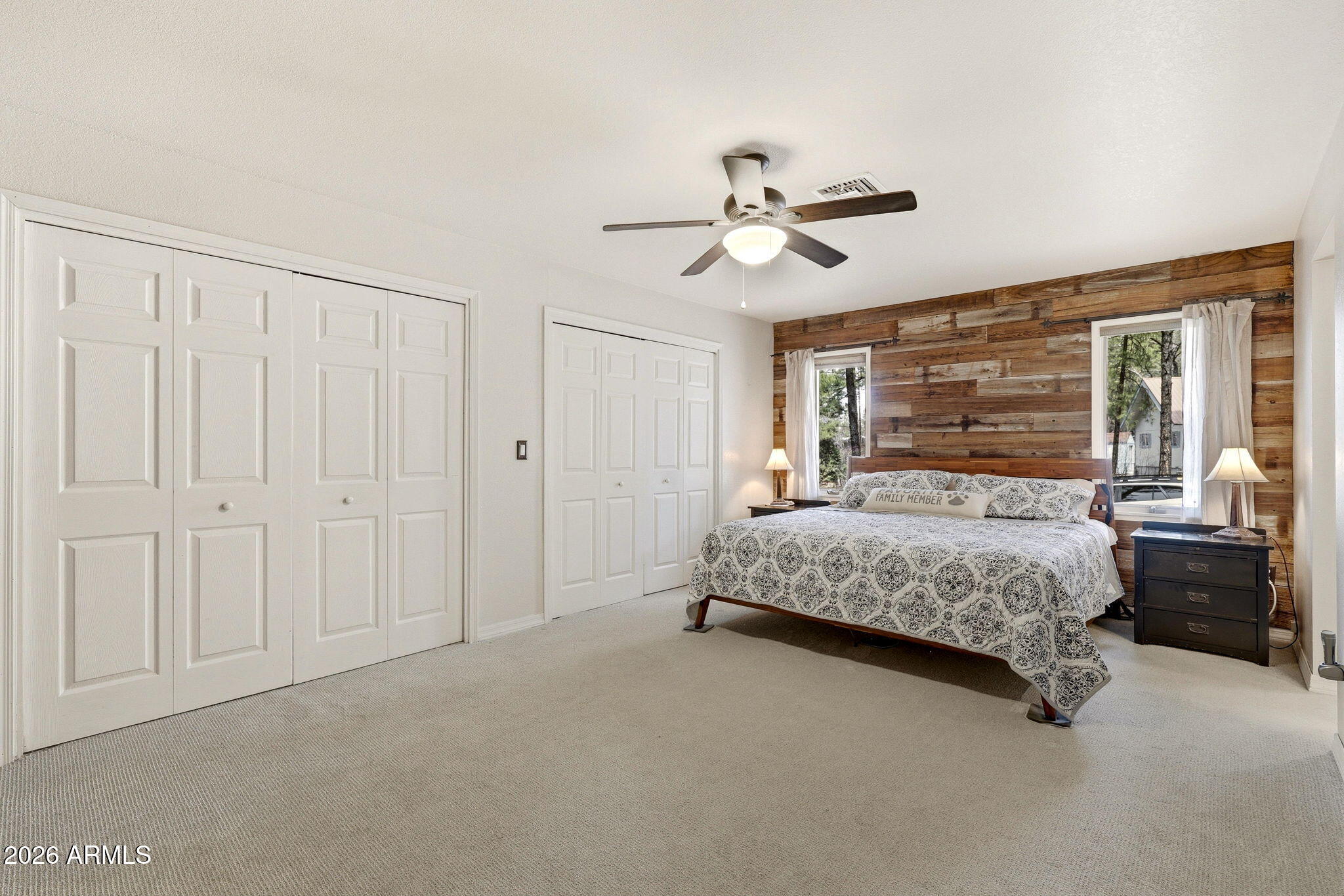 233 East Turkey Track Lane Pinetop, AZ 85935 - Photo 18 of 59 a bedroom with a large bed chandelier and a window
