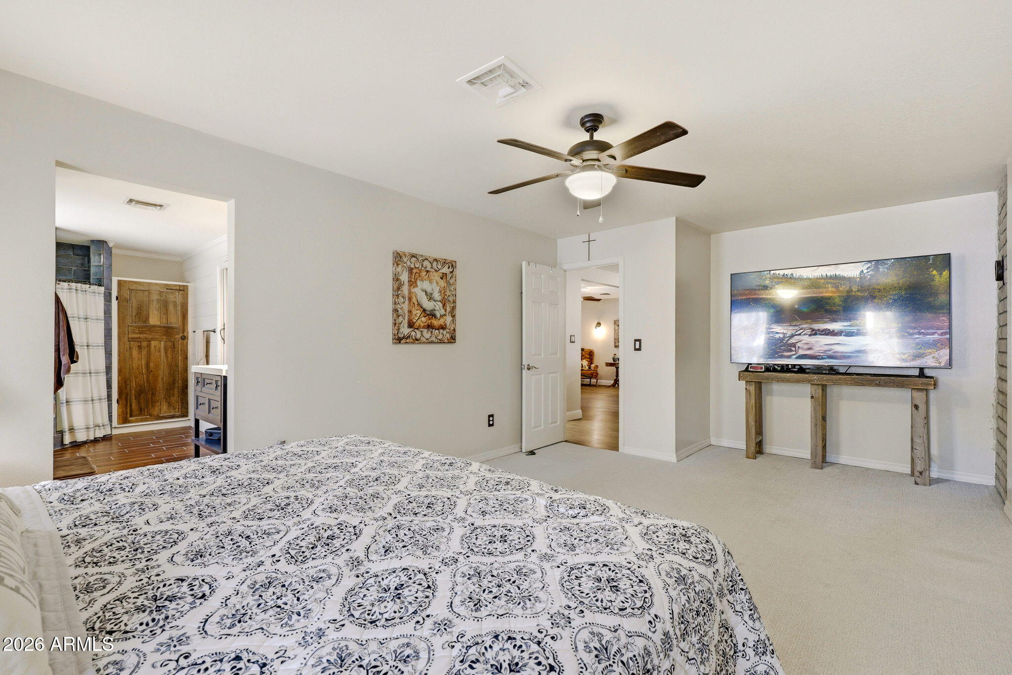 233 East Turkey Track Lane Pinetop, AZ 85935 - Photo 19 of 59 a bedroom with a bed and a flat screen tv