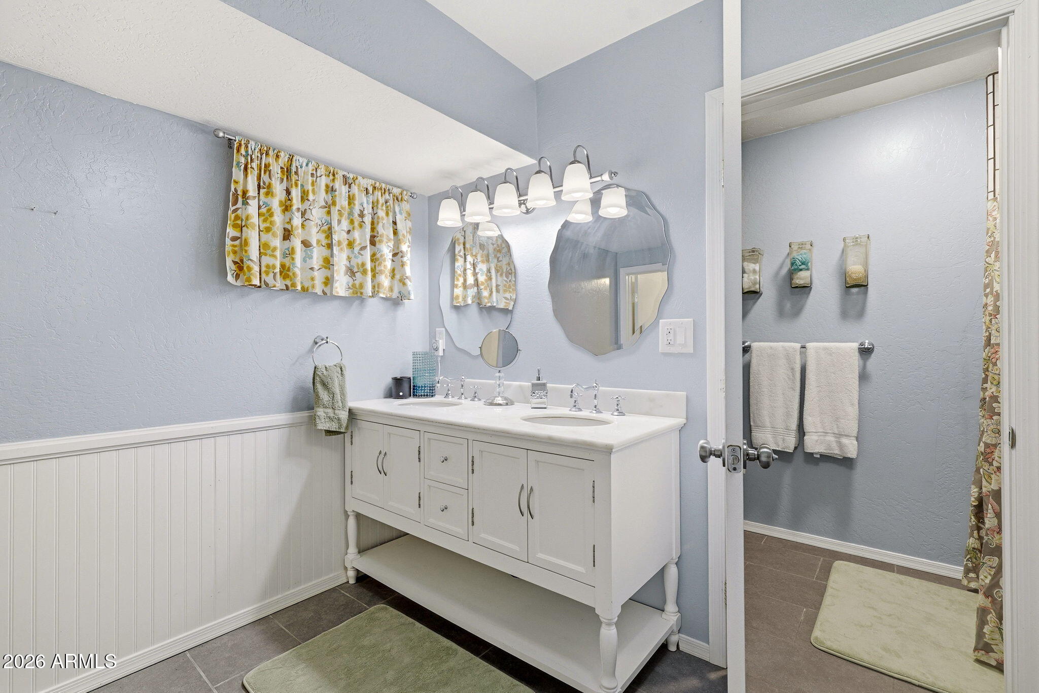 233 East Turkey Track Lane Pinetop, AZ 85935 - Photo 27 of 59 a bathroom with a sink a mirror and a shower