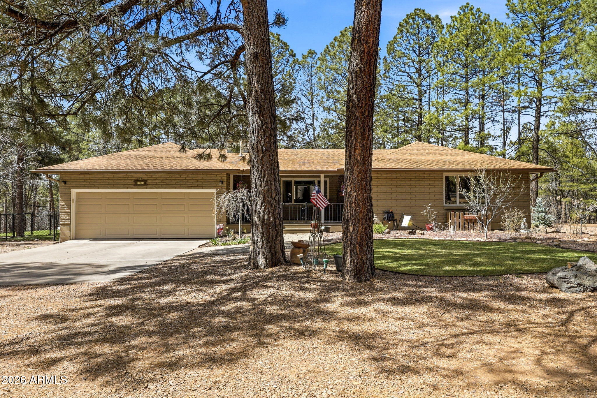 233 East Turkey Track Lane Pinetop, AZ 85935 - Photo 45 of 59 a front view of a house with a yard and garage