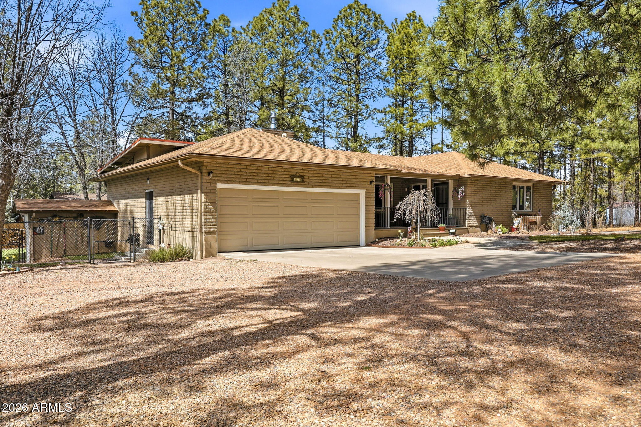 233 East Turkey Track Lane Pinetop, AZ 85935 - Photo 49 of 59 a front view of a house with a yard and garage