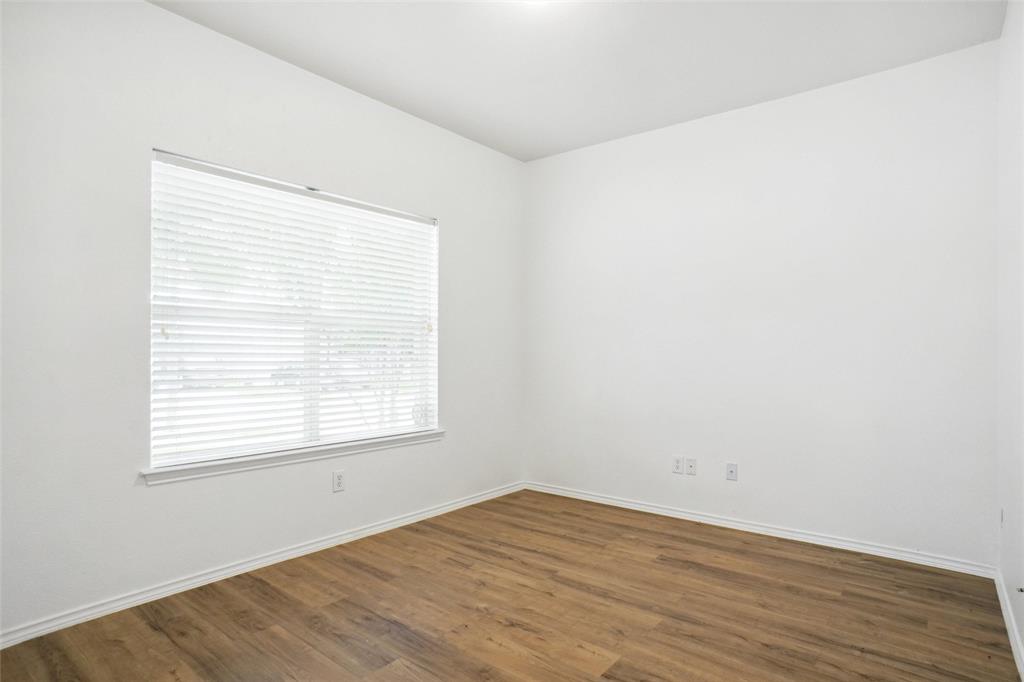 3752 Jade Street Fort Worth, TX 76244 - Photo 14 of 34 an empty room with wooden floor and windows