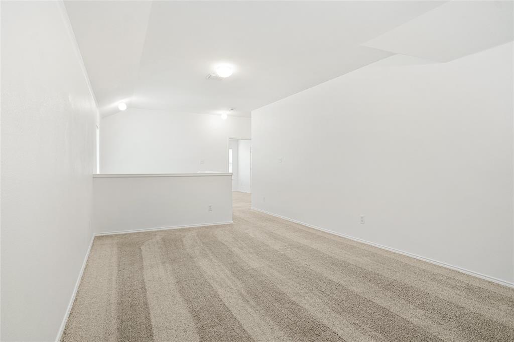 3752 Jade Street Fort Worth, TX 76244 - Photo 18 of 34 a view of a room with wooden floor and brick wall