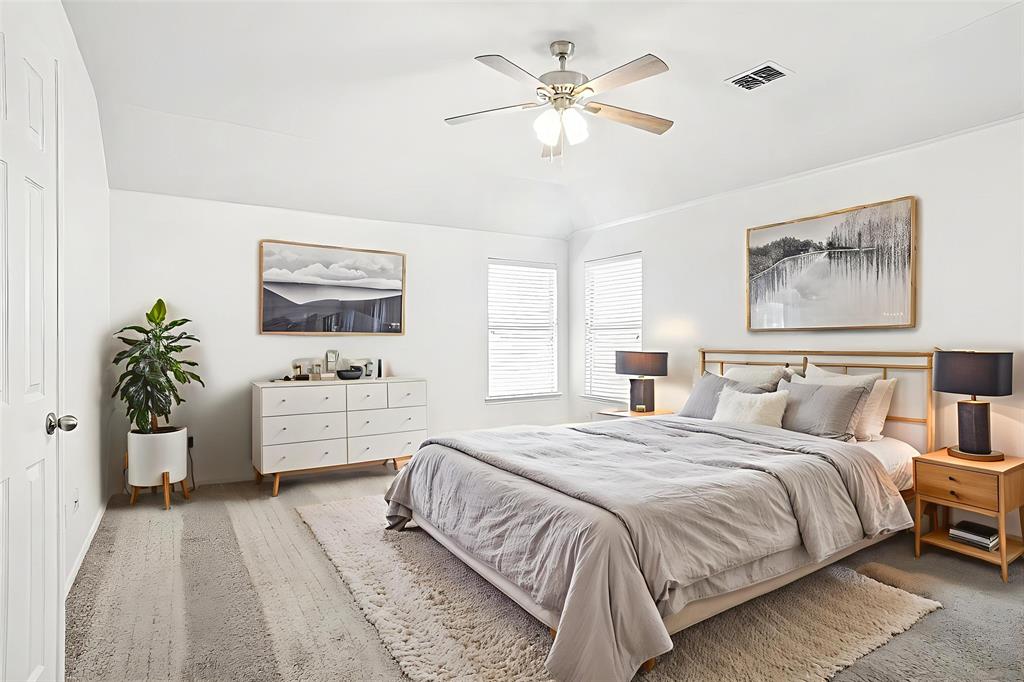 3752 Jade Street Fort Worth, TX 76244 - Photo 19 of 34 a bedroom with a large bed and a chandelier