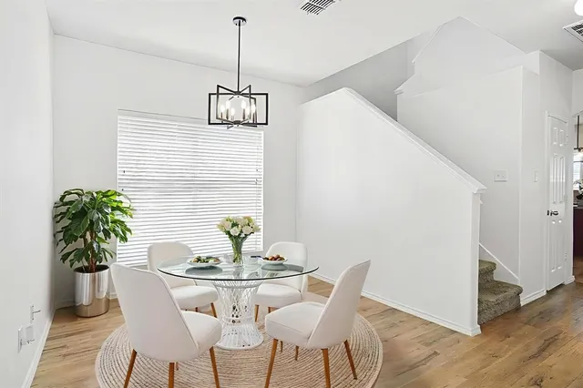 a dining room with furniture and wooden floor