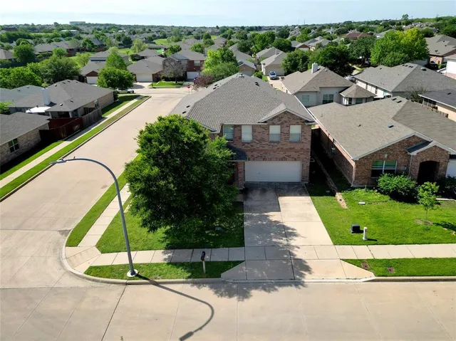 a aerial view of a house with a garden and plants