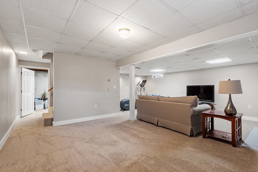 92 Stonegate Road, Unit 92 Chelmsford, MA 01824 - Photo 16 of 32 a living room with furniture and a flat screen tv