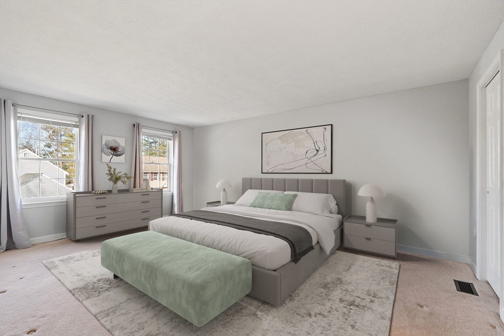 92 Stonegate Road, Unit 92 Chelmsford, MA 01824 - Photo 17 of 32 a spacious bedroom with a bed and a couch