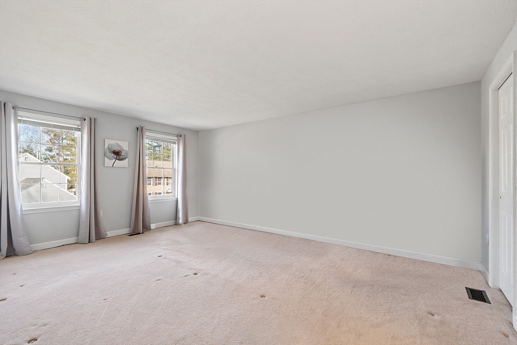 92 Stonegate Road, Unit 92 Chelmsford, MA 01824 - Photo 18 of 32 an empty room with windows