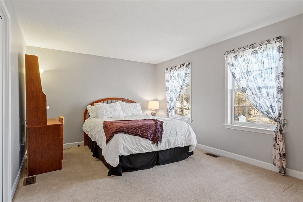 92 Stonegate Road, Unit 92 Chelmsford, MA 01824 - Photo 19 of 32 a bedroom with a bed and window