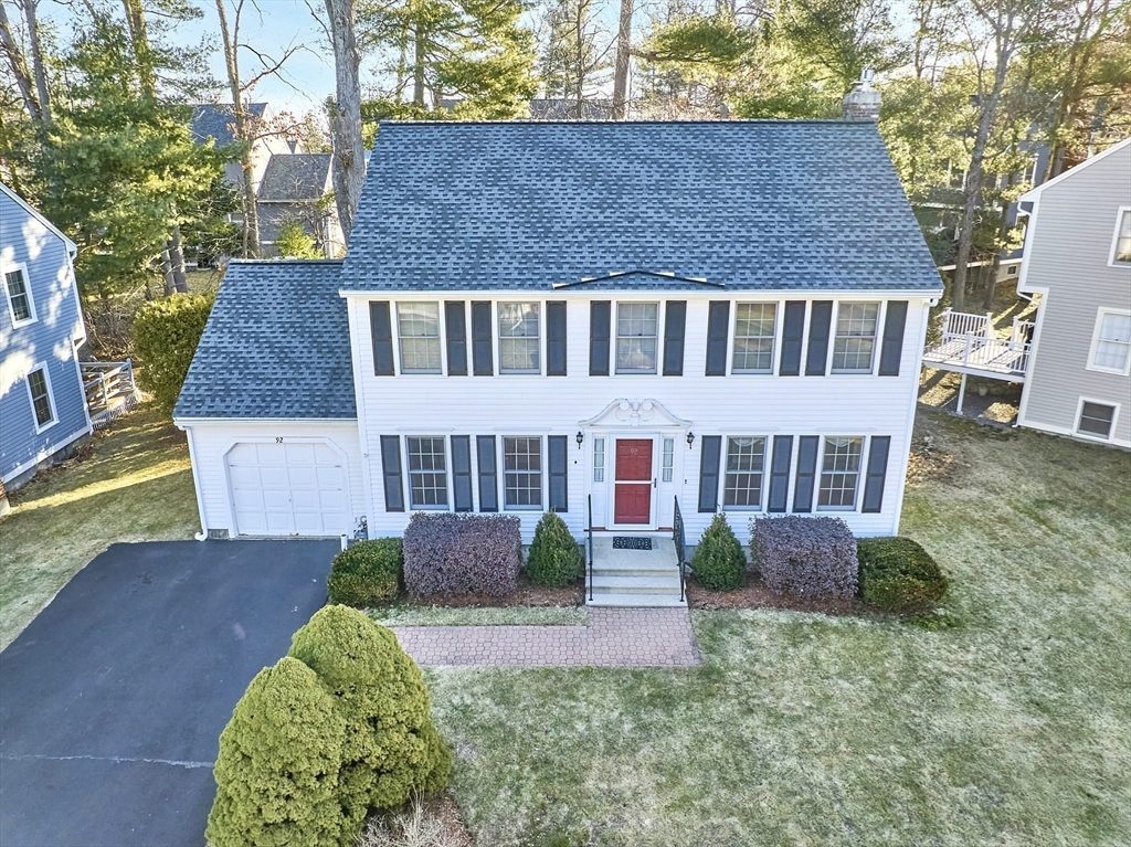 92 Stonegate Road, Unit 92 Chelmsford, MA 01824 - Photo 2 of 32 a front view of a house with garden