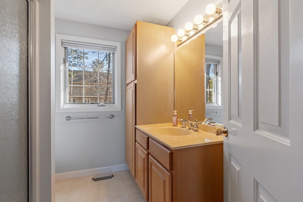 92 Stonegate Road, Unit 92 Chelmsford, MA 01824 - Photo 22 of 32 a bathroom with a sink and a mirror