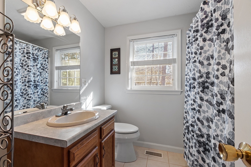 92 Stonegate Road, Unit 92 Chelmsford, MA 01824 - Photo 23 of 32 a sink and a toilet sitting next to a window