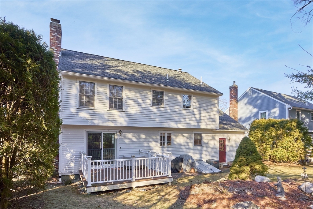 92 Stonegate Road, Unit 92 Chelmsford, MA 01824 - Photo 27 of 32 a view of a brick house with a small yard