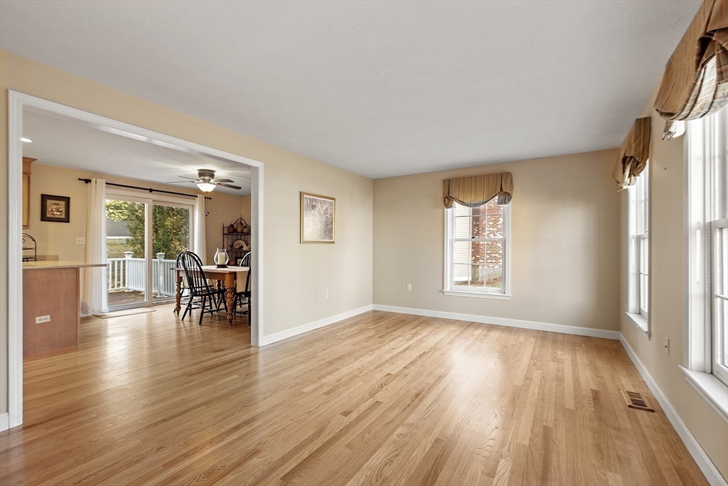 92 Stonegate Road, Unit 92 Chelmsford, MA 01824 - Photo 7 of 32 wooden floor in an empty room with a window