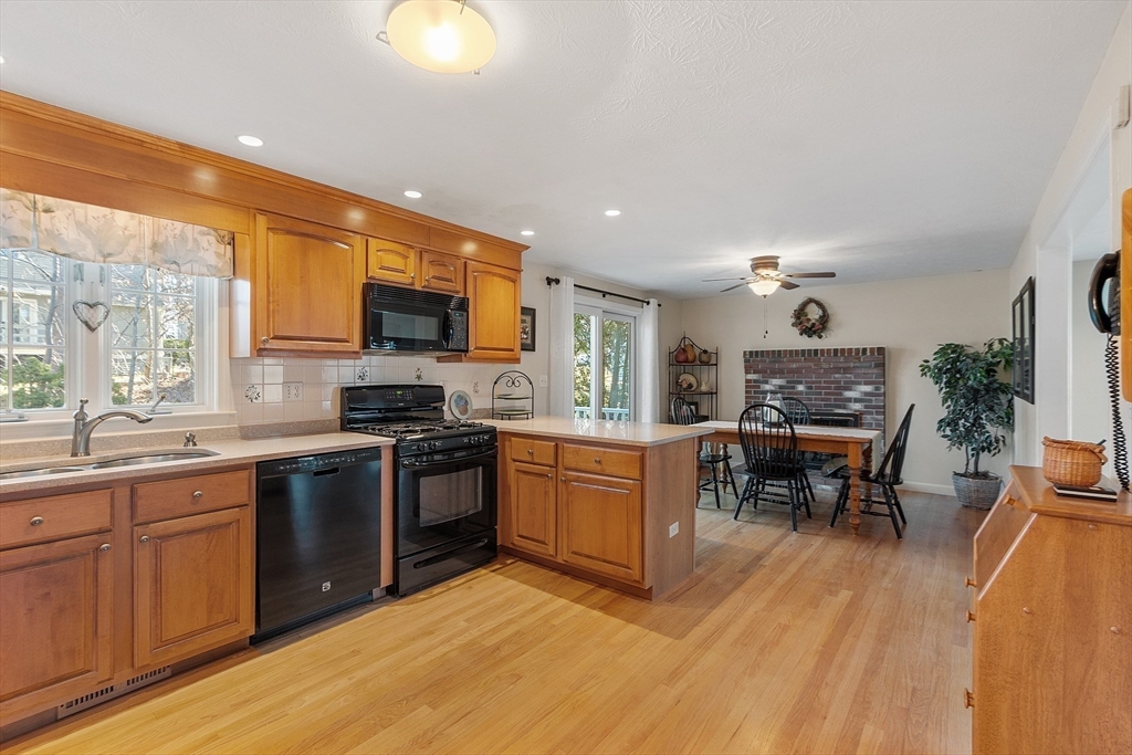 92 Stonegate Road, Unit 92 Chelmsford, MA 01824 - Photo 10 of 32 a kitchen with stainless steel appliances granite countertop sink stove top oven and cabinets