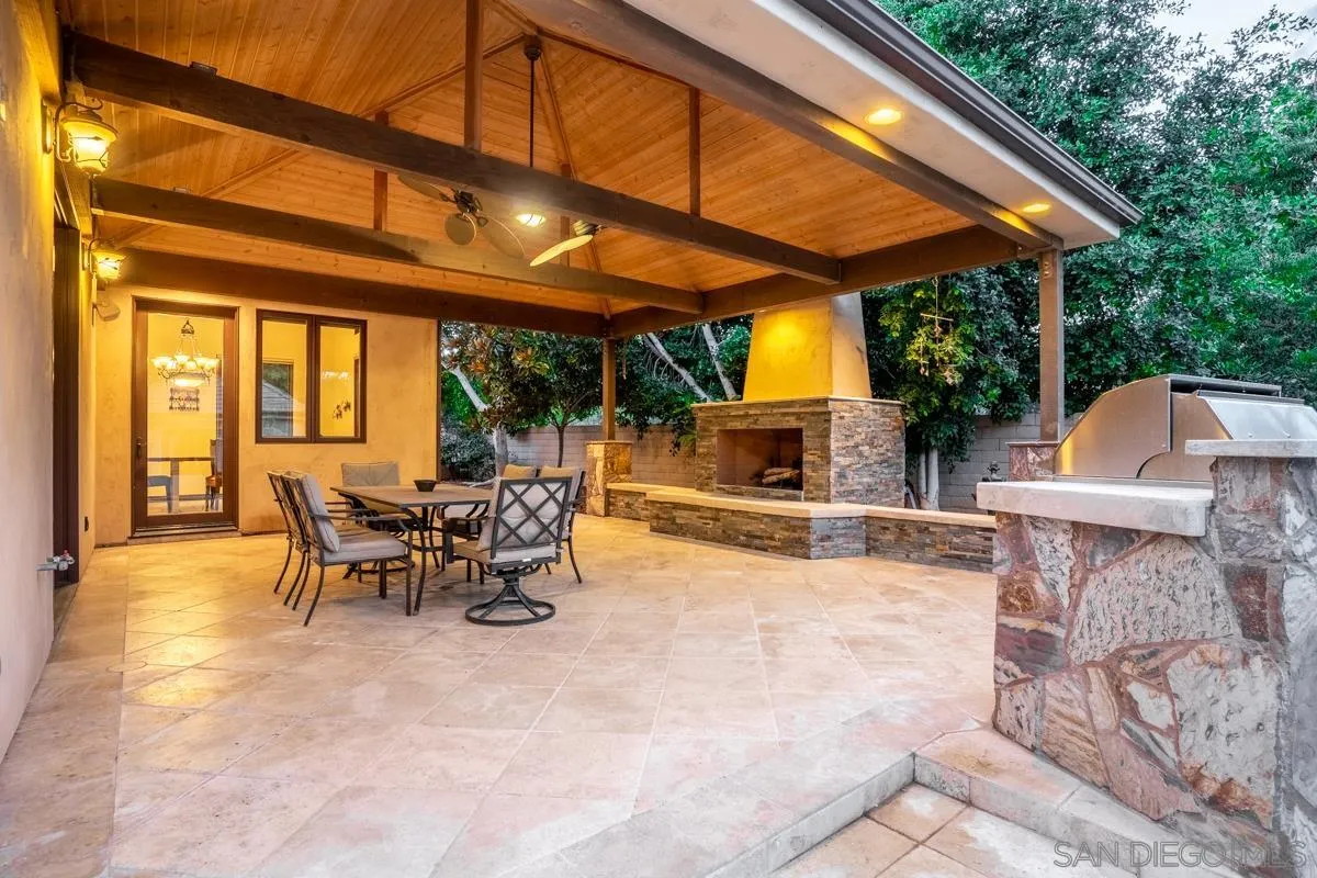 16072 Cross Fox Court Poway, CA 92064 - Photo 31 of 70 a view of a patio with a table and chairs under an umbrella with a barbeque