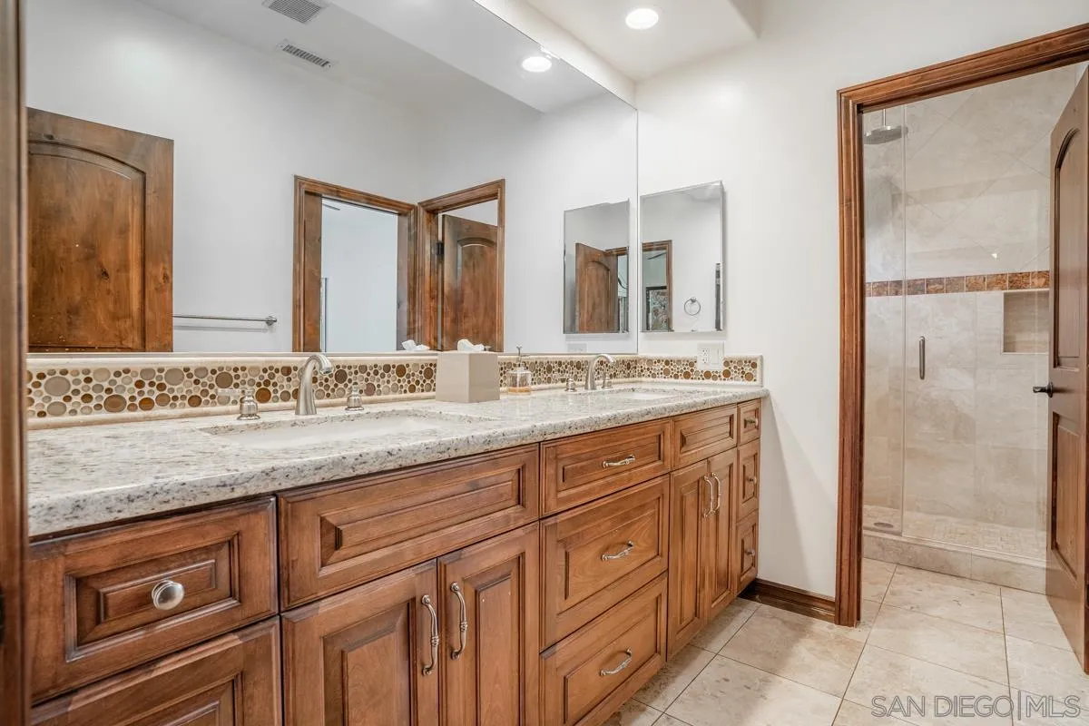 16072 Cross Fox Court Poway, CA 92064 - Photo 60 of 70 a bathroom with a granite countertop sink mirror and cabinets