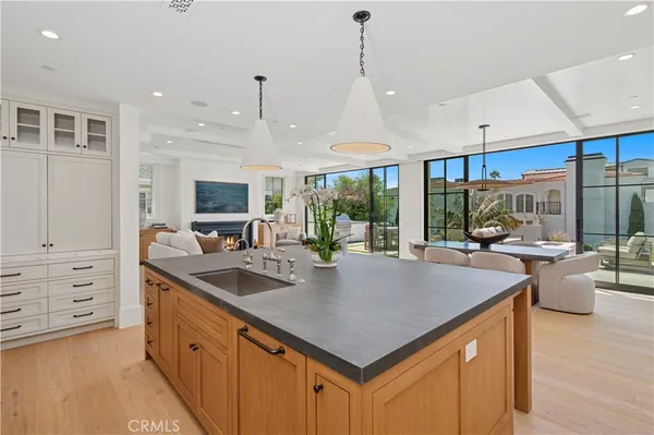 a kitchen with sink a counter and chairs