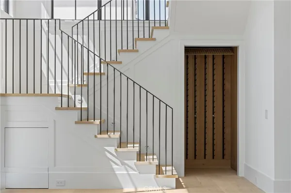 a view of staircase with railing and a window