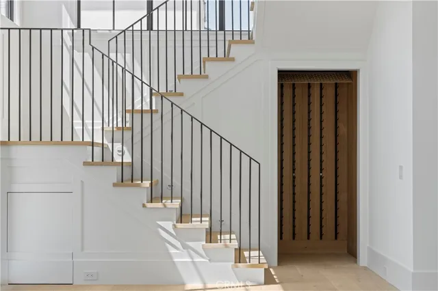 a view of staircase with railing and a window