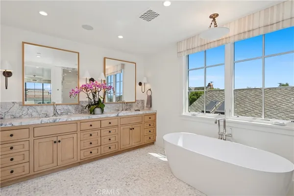 a bathroom with a granite countertop sink a large mirror and shower