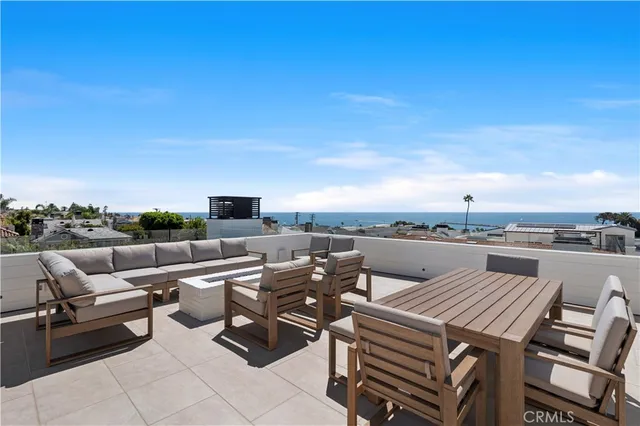 a terrace with outdoor seating and city view