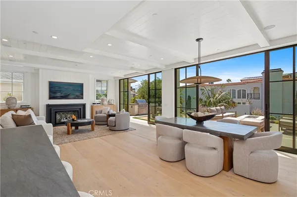 a living room with furniture fireplace and a large window