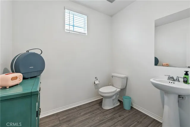 a spacious bedroom with a bed and a flat screen tv