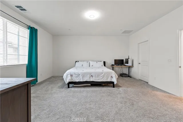 a bedroom with a bed and a lamp