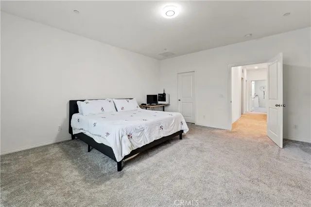 a bed room with a bed and a television