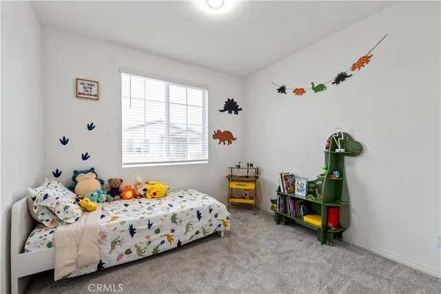 a bed sitting in a bedroom next to a window