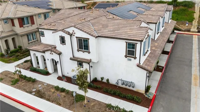 an aerial view of residential houses with street